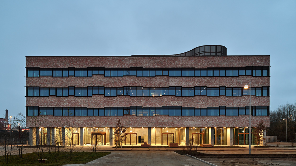 Banedanmarks kontorbygning i Ringsted set udefra, oplyst i tusmørke